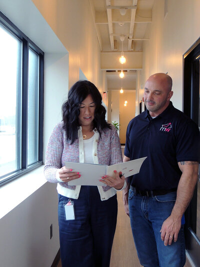 Two Mailworks staff reviewing a campaign proof together